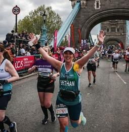 Bethan running across Tower Bridge during the London Marathon