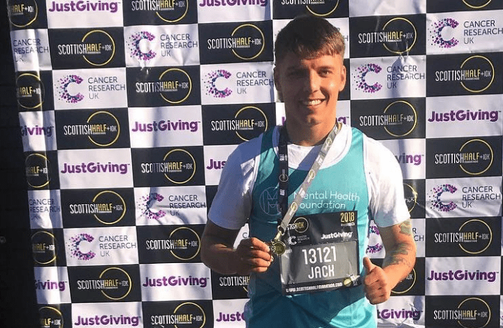 Photo of a runner, Jack, with his medal having finished the Scottish Half Marathon